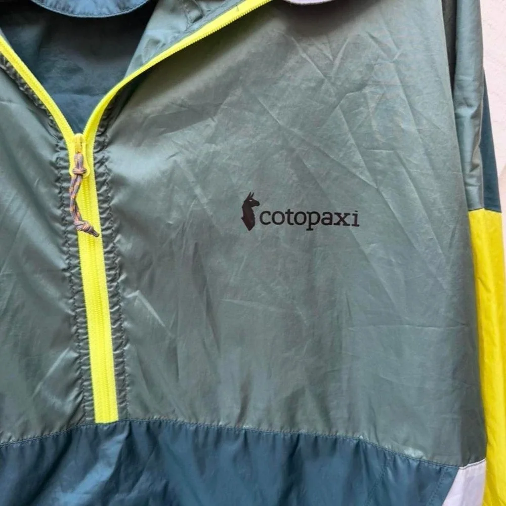 Cotopaxi windbreaker with hood jacket in green, yellow, and teal M